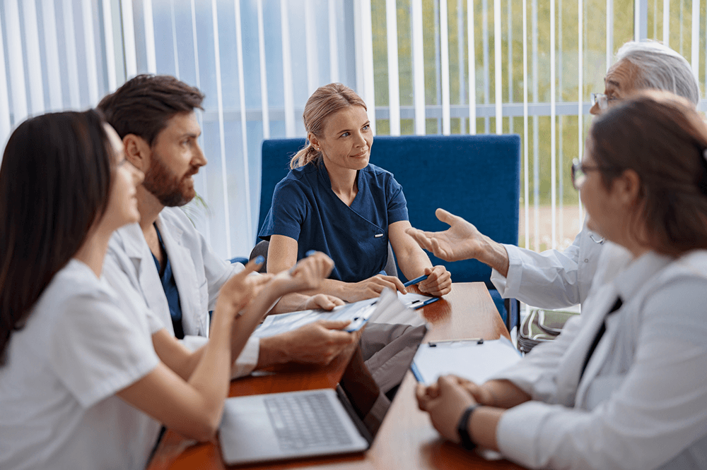 A clinical team meeting around a table